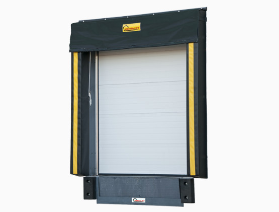 A closed industrial loading dock door with a black and yellow dock shelter surrounds it, showcasing premium loading dock shelters and seals Chatham for efficient truck loading and unloading.